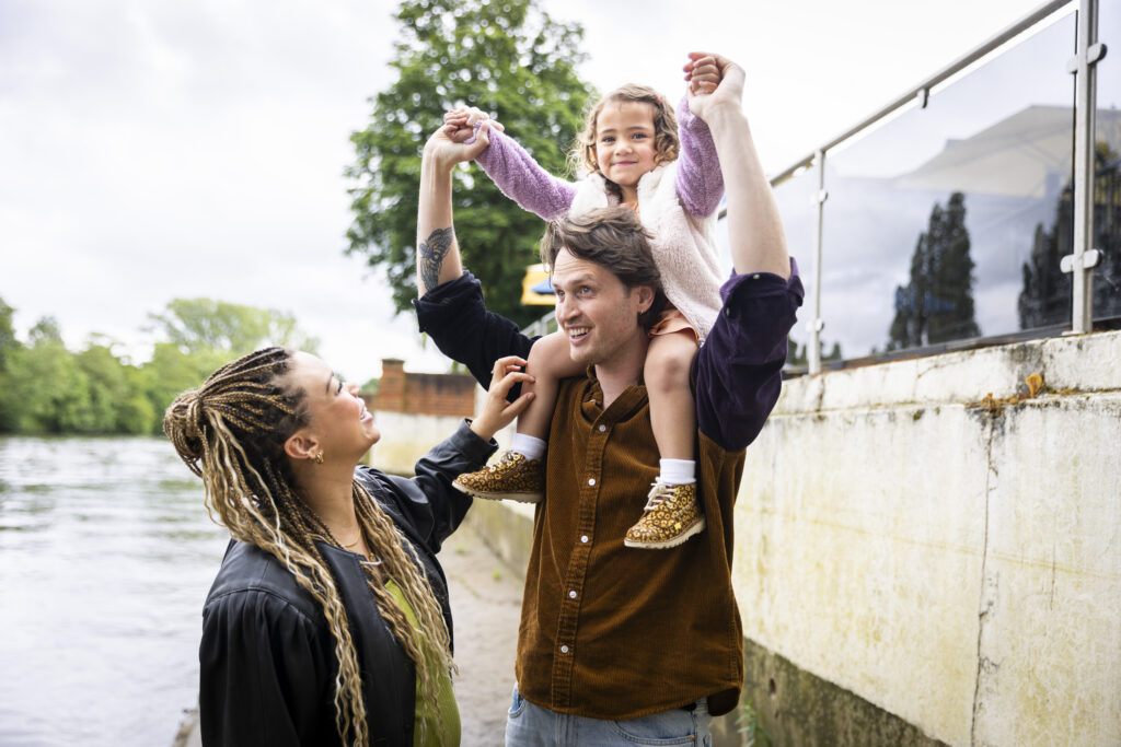 An adoptive couple with their daughter
