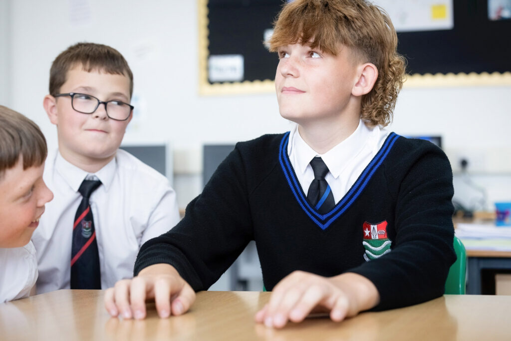 Boys around table in classroom