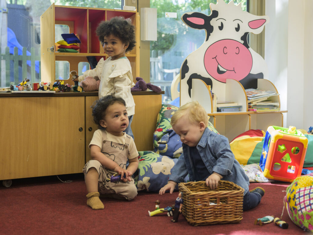 Three children playing at nursery