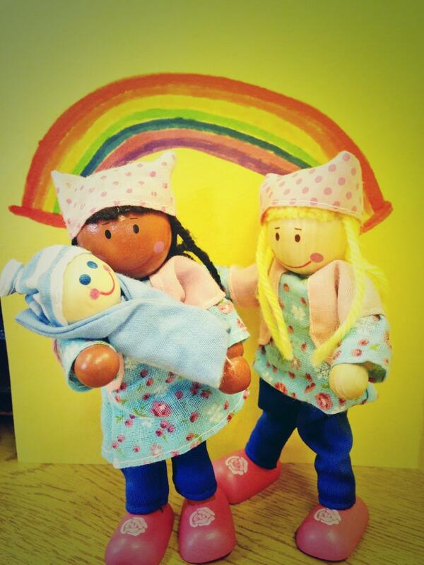 Model of two mums holding baby