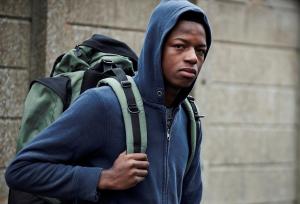 Young homeless teen with his rucksack